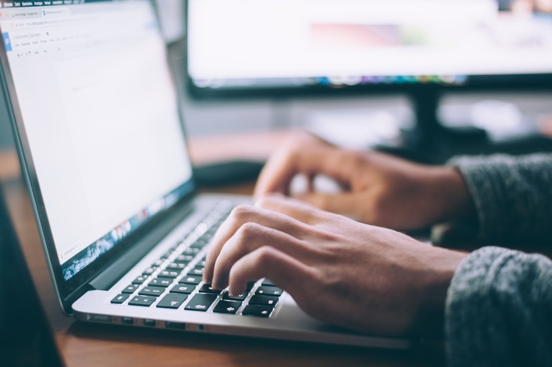 Person writing blog content on a laptop for affiliate marketing